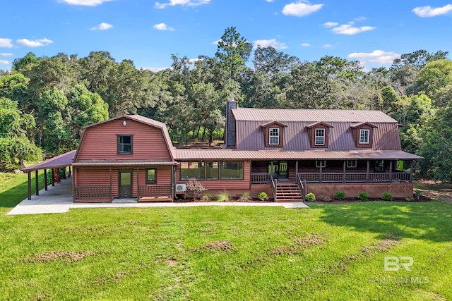 back of property with a porch, a yard, and a carport