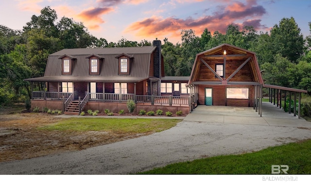 log cabin featuring a porch and a lawn