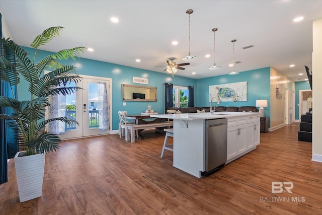 kitchen with dark wood finished floors, visible vents, open floor plan, white cabinetry, and dishwasher