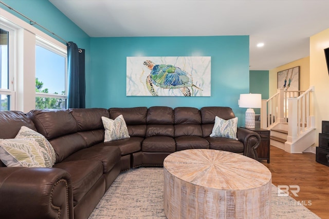 living area with recessed lighting, stairway, and wood finished floors