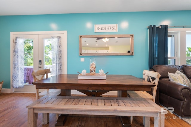 dining space with french doors and wood finished floors