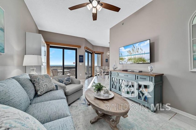 living room with ceiling fan and light tile patterned floors