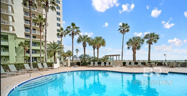 375 Beach Club Trl Unit A1704, Gulf Shores, AL 36542 - community pool featuring a patio area and fence
