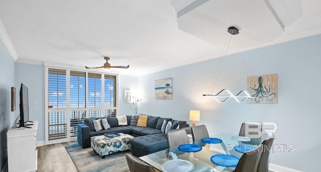 375 Beach Club Trl Unit A1704, Gulf Shores, AL 36542 - living area with wood finished floors, ornamental molding, ceiling fan, and baseboards