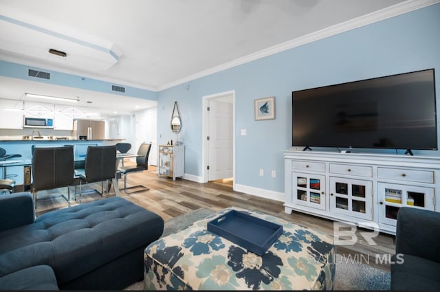375 Beach Club Trl Unit A1704, Gulf Shores, AL 36542 - living room featuring wood finished floors, crown molding, and baseboards