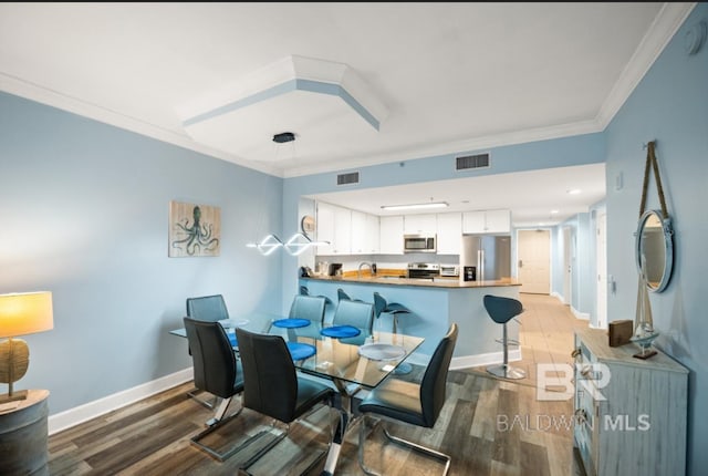375 Beach Club Trl Unit A1704, Gulf Shores, AL 36542 - dining space with wood finished floors, crown molding, and baseboards