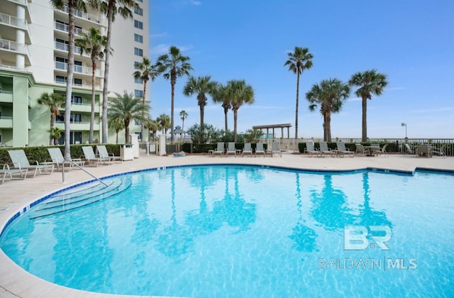 375 Beach Club Trl Unit A1704, Gulf Shores, AL 36542 - community pool featuring a patio and fence