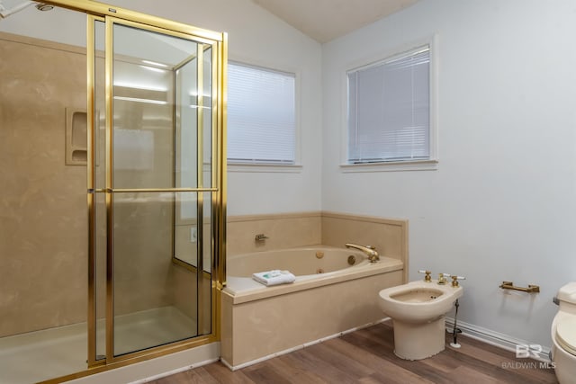 full bathroom with toilet, a jetted tub, wood finished floors, a bidet, and a shower stall