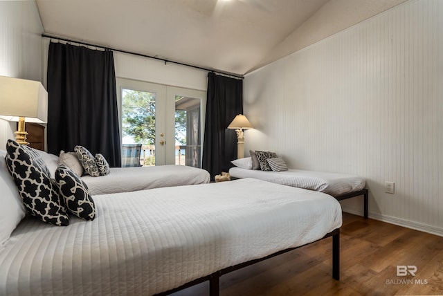 bedroom featuring access to outside, wood finished floors, french doors, baseboards, and vaulted ceiling