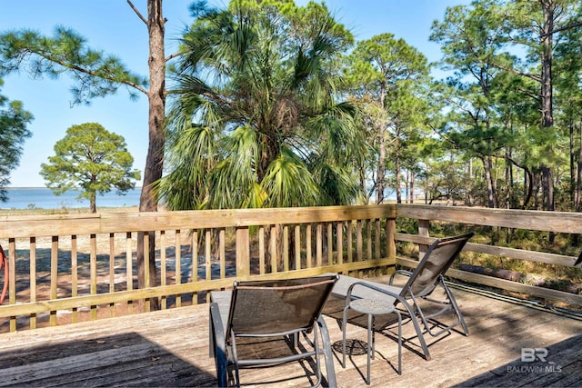 wooden terrace featuring a water view