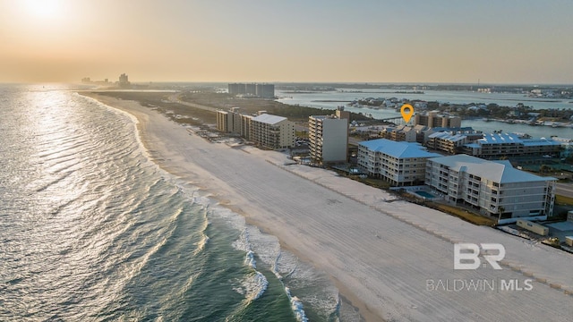 aerial view with a water view and a beach view