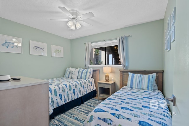 bedroom featuring a ceiling fan and a textured ceiling