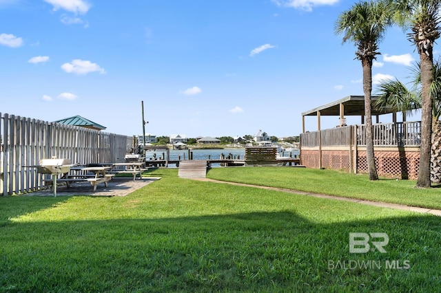 view of yard with fence and a water view