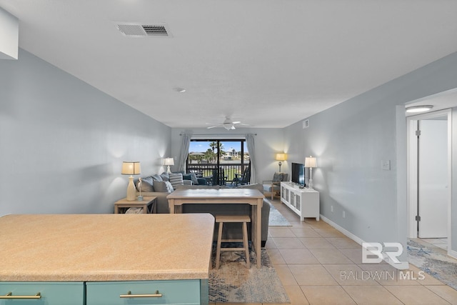 kitchen with visible vents, baseboards, open floor plan, ceiling fan, and light tile patterned flooring