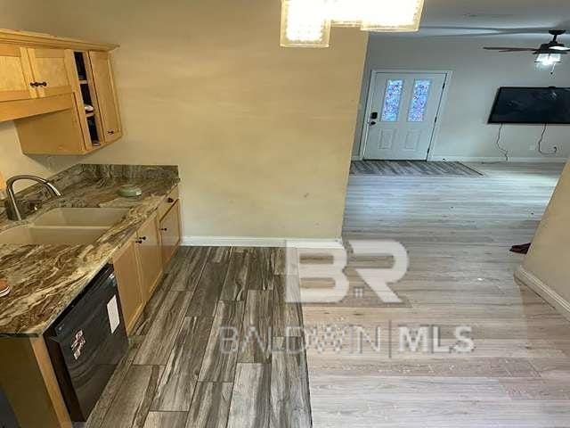 21800 Old Brady Rd, Robertsdale, AL 36567 - kitchen with a sink, baseboards, a ceiling fan, black dishwasher, and wood finished floors