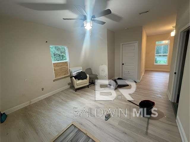 21800 Old Brady Rd, Robertsdale, AL 36567 - unfurnished room featuring a ceiling fan, wood finished floors, and baseboards