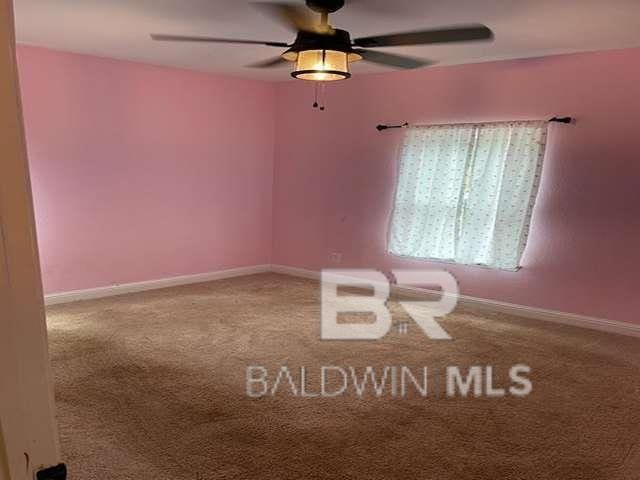 21800 Old Brady Rd, Robertsdale, AL 36567 - empty room with a ceiling fan, carpet, and baseboards