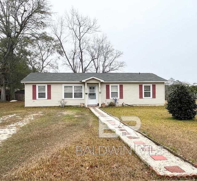 ranch-style home with a front lawn