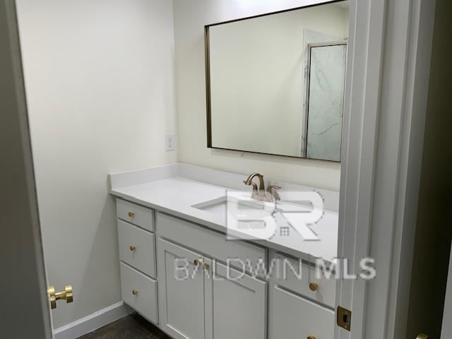 bathroom with walk in shower and vanity