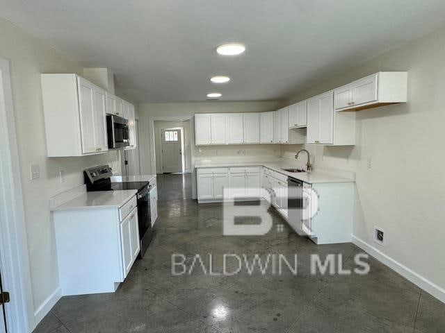 kitchen with stainless steel appliances, sink, and white cabinetry