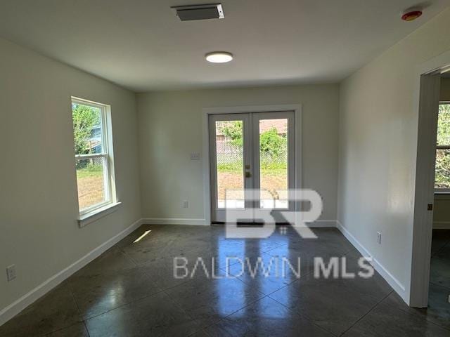 unfurnished room featuring plenty of natural light