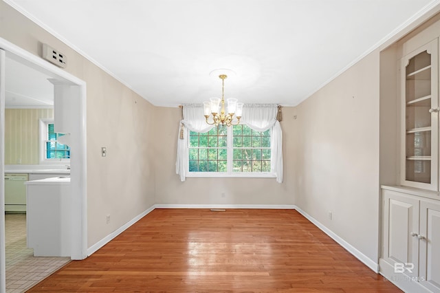 unfurnished dining area with crown molding, a notable chandelier, and light hardwood / wood-style floors