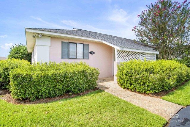 view of side of property with a yard