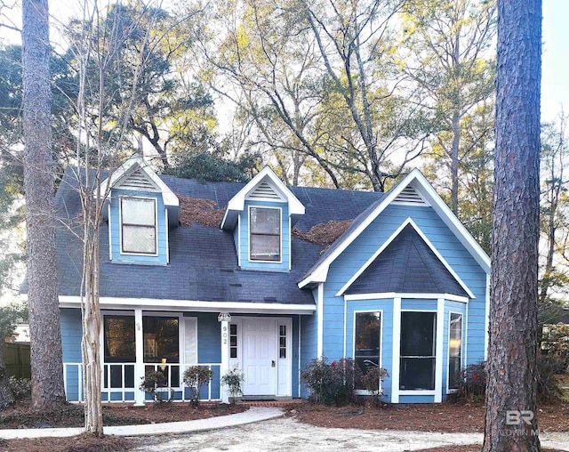 new england style home with a porch