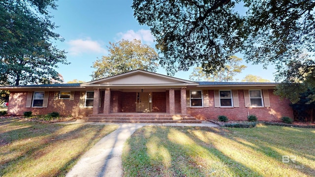 single story home with a front lawn and a porch