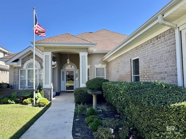 property entrance with a lawn