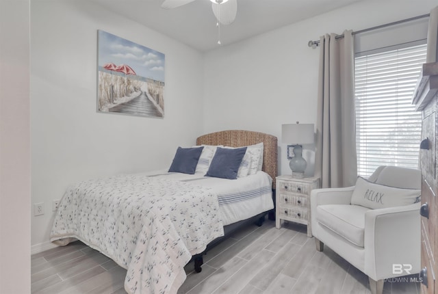 27405 Polaris St Unit 302, Orange Beach, AL 36561 - bedroom featuring wood finish floors, multiple windows, ceiling fan, and baseboards
