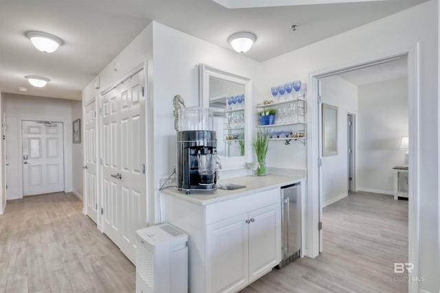 27405 Polaris St Unit 302, Orange Beach, AL 36561 - bar area with wine cooler, light wood-style floors, and baseboards