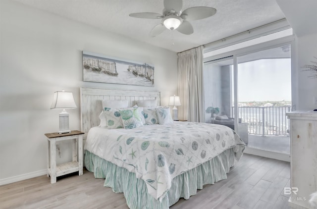 27405 Polaris St Unit 302, Orange Beach, AL 36561 - bedroom with multiple windows, access to outside, and wood finished floors