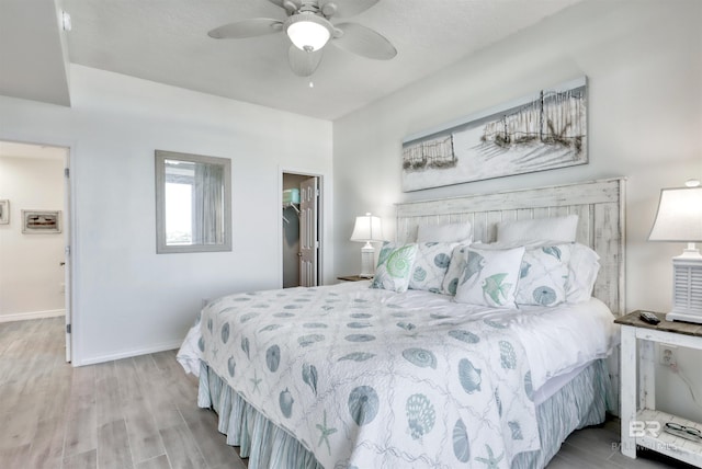 27405 Polaris St Unit 302, Orange Beach, AL 36561 - bedroom featuring a spacious closet, wood finished floors, a ceiling fan, and baseboards