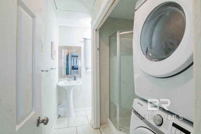 washroom featuring sink and stacked washer / dryer