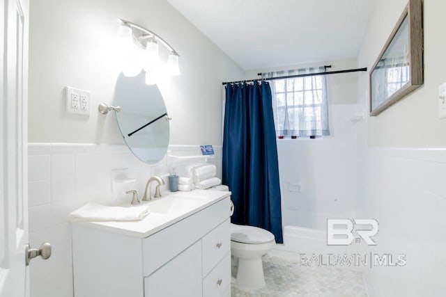 full bathroom with tile patterned flooring, vanity, tile walls, toilet, and shower / tub combo with curtain