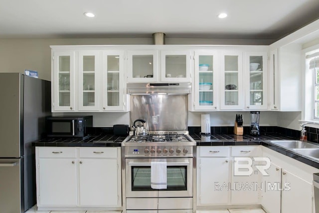 kitchen featuring sink, white cabinetry, and appliances with stainless steel finishes