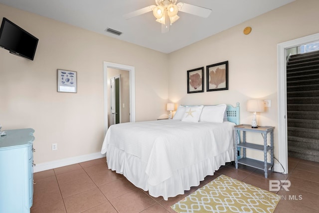 bedroom featuring tile patterned flooring, visible vents, baseboards, and ceiling fan