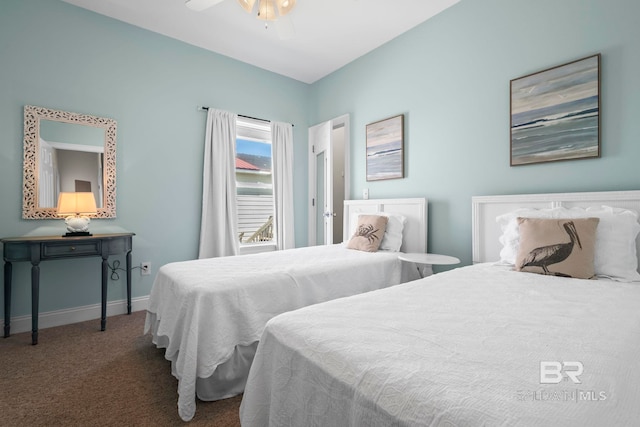 carpeted bedroom with ceiling fan and baseboards