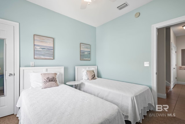 bedroom featuring visible vents, tile patterned floors, ceiling fan, and baseboards
