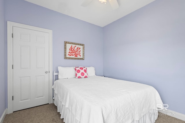 carpeted bedroom featuring baseboards and a ceiling fan