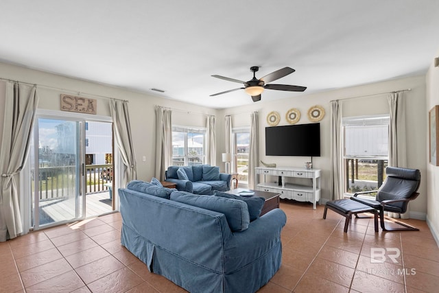 living room with visible vents, tile patterned floors, and ceiling fan