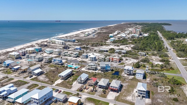 drone / aerial view with a beach view and a water view