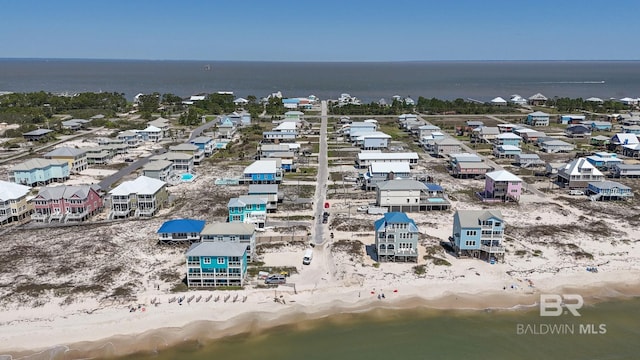 birds eye view of property featuring a water view and a view of the beach
