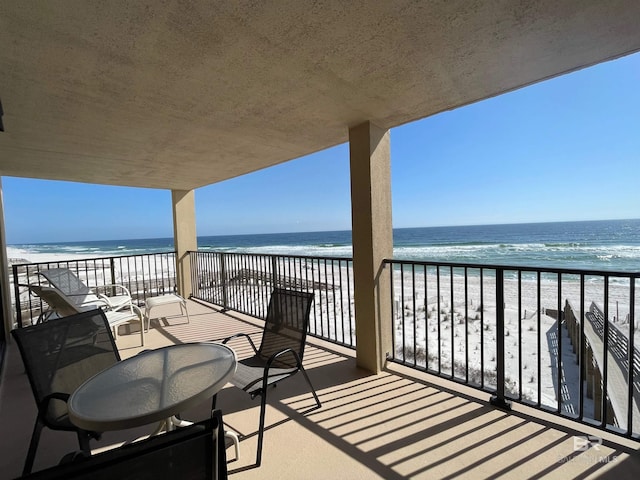 balcony with a view of the beach and a water view