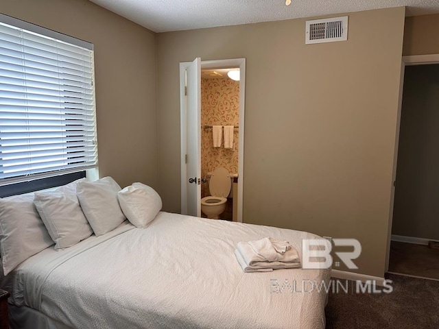 carpeted bedroom with a textured ceiling