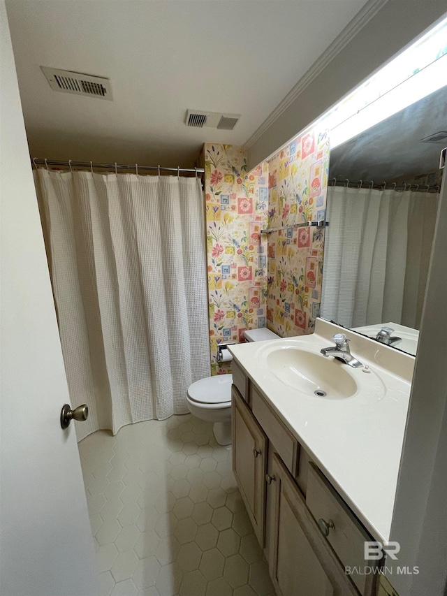 bathroom with vanity, ornamental molding, tile patterned floors, and toilet