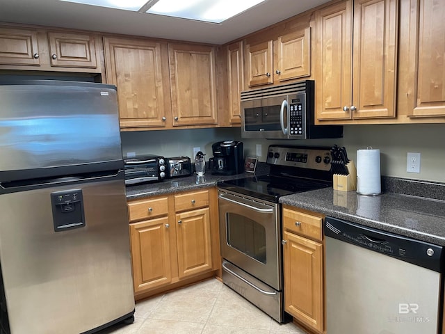 kitchen featuring light tile patterned floors and appliances with stainless steel finishes