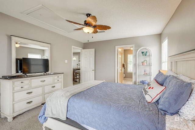 9581 S Bay Rd, Foley, AL 36535 - bedroom with ceiling fan, connected bathroom, light carpet, and a textured ceiling