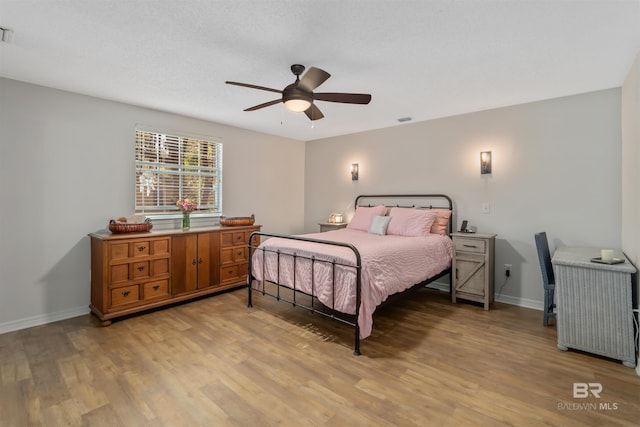 bedroom featuring light wood-type flooring and ceiling fan